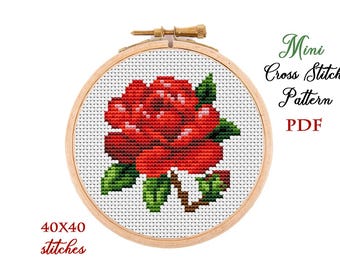 May include: A red rose cross stitch pattern in a wooden embroidery hoop. The pattern is 40x40 stitches and is available as a PDF download.  Mini Cross Stitch Pattern PDF.