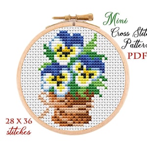 May include: A cross stitch pattern featuring a small bouquet of purple and yellow pansies in a brown pot. The pattern is 28 stitches wide by 36 stitches high. The pattern is labelled "Mini Cross Stitch Pattern PDF".