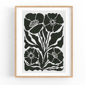 Op de afbeelding: Zwart-witte kruissteekpatroon van gestileerde bloemen met bladeren. De bloemen zijn in een eenvoudige, geometrische stijl.