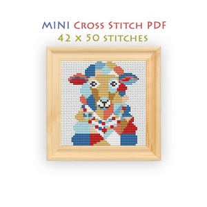 May include: A cross stitch pattern titled MINI CROSS STITCH PDF 42 x 50 STITCHES featuring a stylized sheep composed of geometric blocks in shades of blue, red, tan, and white, displayed within a light-colored wooden square frame.
