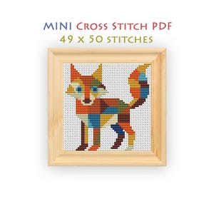 May include: A cross stitch pattern titled MINI CROSS STITCH PDF 49 x 50 STITCHES featuring a multi-colored fox composed of geometric shapes in shades of orange, blue, brown, and yellow, displayed within a light-toned wooden square frame.