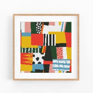May include: A square cross-stitch pattern featuring a vibrant patchwork of geometric shapes and textures in red, yellow, blue, green, black, and white, displayed within a light-toned wooden frame with a clean, square border design.