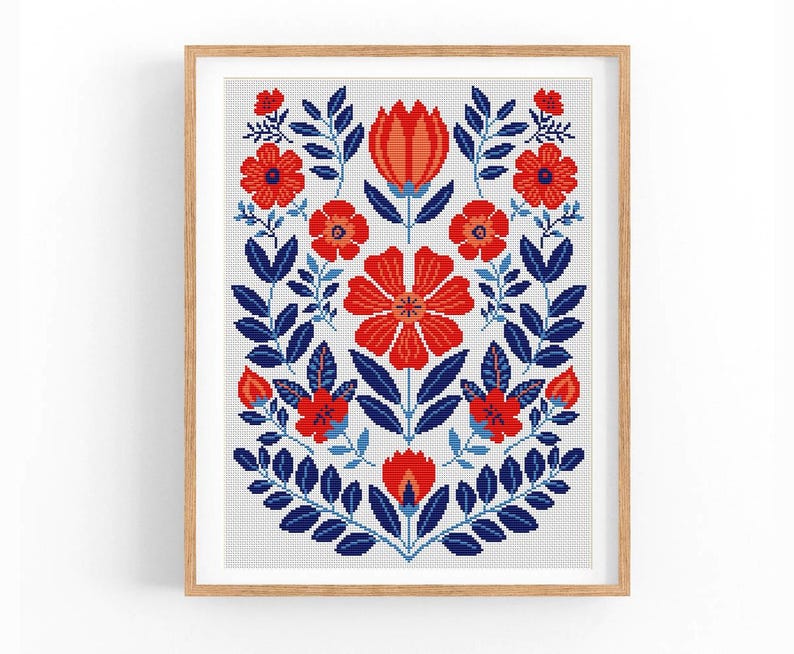 May include: A cross-stitch pattern featuring a floral design with red and blue flowers and leaves on a white background.