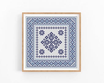 May include: A framed cross-stitch pattern with a blue and white geometric design. The pattern features a central diamond shape with smaller diamond shapes within it.