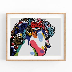 May include: A colourful cross-stitch pattern of a person's head with a detailed design of flowers and swirls. The colours are bright and vibrant, including red, blue, green, yellow, and purple.