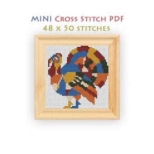 May include: A mini cross stitch PDF pattern featuring a turkey design with a colorful mosaic of blue, orange, yellow, and green stitches. The text MINI CROSS STITCH PDF 48 x 50 STITCHES is displayed above the turkey, which is framed in light wood.
