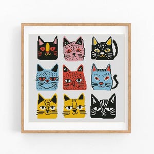 May include: A cross-stitch pattern featuring nine colorful cat faces with different expressions. The cats are arranged in a grid pattern with a black frame.