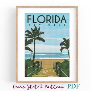 May include: A framed cross-stitch pattern featuring a beach scene in Key West, Florida. The artwork depicts a sandy path leading to the ocean, framed by palm trees and a blue sky. The text "FLORIDA KEY WEST" is at the top, with "Cross Stitch Pattern PDF" at the bottom.