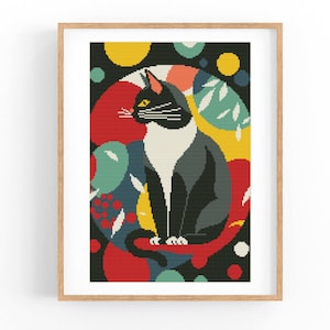 Puede incluir: Un gato blanco y negro con ojos amarillos se sienta en un círculo de formas abstractas de colores. El fondo es negro con formas rojas, amarillas, verdes y azules.