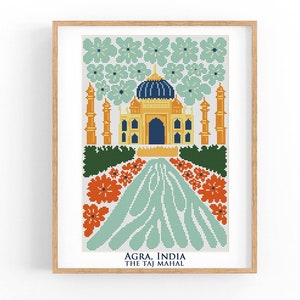 May include: A cross-stitch pattern of the Taj Mahal in Agra, India. The image features a white background with a yellow and blue Taj Mahal, surrounded by green trees and orange flowers.
