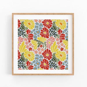 May include: A framed floral cross-stitch pattern. The design features a repeating pattern of red, yellow, pink, and blue flowers with green leaves. The artwork is displayed in a light brown wooden frame.
