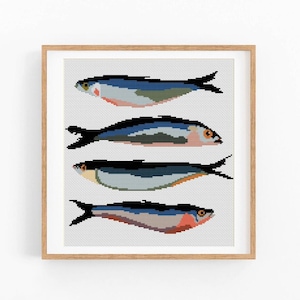 May include: A framed print showing four stylized fish illustrations. Each fish is rendered in a pixelated style, using blues, greens, and reds. The artwork is set against a light grey background, and framed in natural wood.