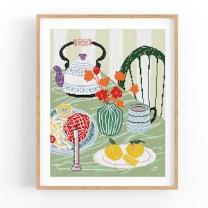 May include: A framed print of a still life scene. The image features a table set with a teapot, a vase of flowers, a plate of food, and a mug. The color palette includes green, white, red, and orange.