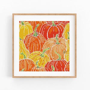 May include: A square framed cross-stitch pattern featuring a dense arrangement of pumpkins in various shades of orange, yellow, and red. The design uses a pixelated grid style to depict multiple gourds of different sizes and shapes with green stems.