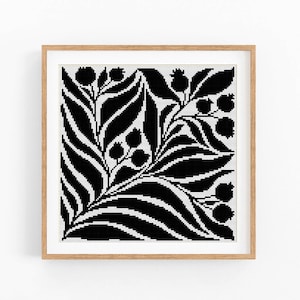 May include: Black and white framed artwork featuring a stylized floral design with leaves and berries.