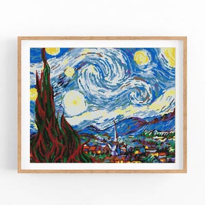 May include: A framed artwork showing a pixelated rendition of Van Gogh's "Starry Night." The image features a swirling blue sky with yellow stars, a dark green cypress tree, and a village with colourful houses. The artwork is in a light brown wooden frame.