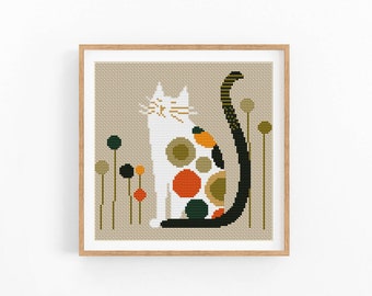 May include: Cross stitch pattern of a white cat with a black tail sitting in a field of green, orange and red flowers. The cat is made up of circles of different colours.