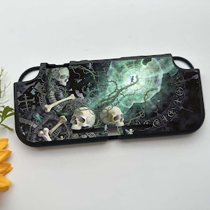 May include: Black Switch case with a detailed fantasy illustration. The artwork features skulls, bones, and a glowing green portal with figures. The case has a glossy finish and a dark, gothic aesthetic.