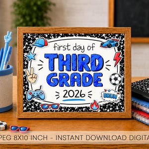 May include: A framed sign with the text first day of THIRD GRADE 2026, featuring blue, red, and black illustrations of a baseball cap, race car, star, peace sign, soccer ball, game controller, sunglasses, and flame on a black and white background.