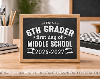 May include: A rectangular chalkboard sign in a light wood frame featuring white text that reads I'M A 6TH GRADER first day of MIDDLE SCHOOL 2026-2027. The sign is displayed on a wooden surface with notebooks and a pencil holder nearby.