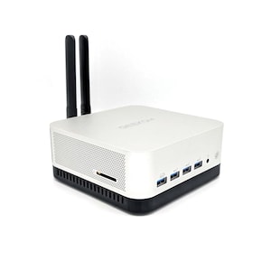 May include: A white and black mini computer with two black antennas. The computer has multiple USB ports, a card reader slot, and the word "GEEKOM" printed on the top. The device is on a white background.