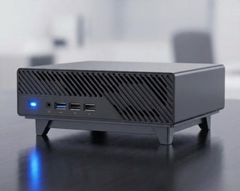 May include: A black mini computer with a slatted front panel and a blue power light. It has multiple USB ports and audio jacks. The computer sits on a black surface.