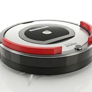 May include: A circular robotic vacuum cleaner with a black and silver finish, featuring two prominent red bumper accents on the top surface. The device includes a central black control panel with a silver button labeled Clean and the iRobot logo.