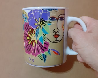 Vintage Laurel Burch coffee mug, woman's face and floral design, inspirational positive saying on a ceramic cup, female face