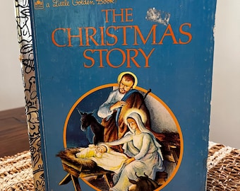 May include: A blue Little Golden Book with the title "The Christmas Story". The cover features an illustration of the nativity scene with Mary, Joseph, and baby Jesus.