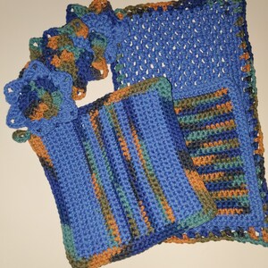 May include: Set of four crocheted dishcloths in blue, green, brown, and orange. The dishcloths are made with a variety of stitches and patterns.