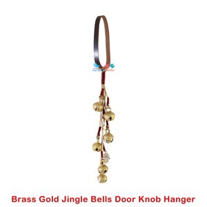 May include: Brass gold jingle bells door knob hanger with a brown leather strap and red and beige tassels.
