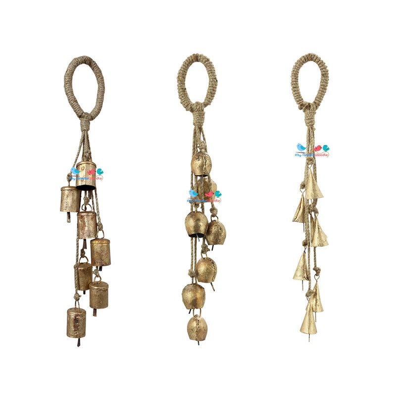 May include: Three gold-coloured metal wind chimes with a jute rope hanger and multiple bells. Each chime has a different style of bell.