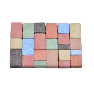May include: A collection of small, square, concrete pavers in various colors, including red, green, blue, and gray. The pavers are arranged in a grid pattern.