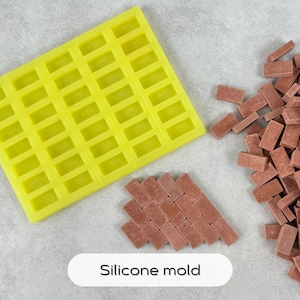 May include: A yellow silicone mold with 48 rectangular cavities, next to a pile of small, red brick-shaped pieces. The text "Silicone mold" is written below the mold.