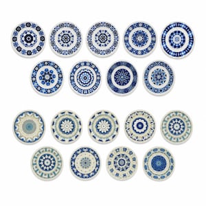 May include: A collection of nineteen round ceramic plates arranged in four rows. The top two rows feature plates with deep blue and white geometric mandala patterns. The bottom two rows display plates with light blue, grey, and white floral designs.