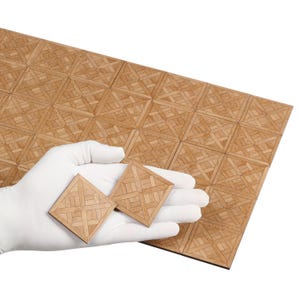 May include: A set of 16 wooden parquet tiles in a light brown colour. The tiles are arranged in a geometric pattern and have a smooth, polished finish. Two individual tiles are shown in the hand of a person.