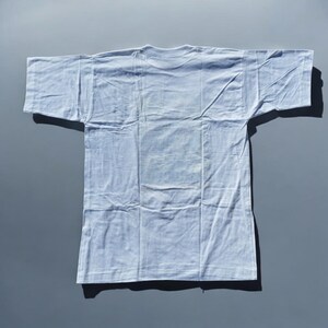 May include: A plain white t-shirt with short sleeves.