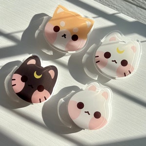 May include: Four colourful cartoon animal stickers with a crescent moon design. The stickers are on a white surface.