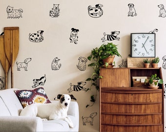 May include: A white couch with a patterned throw pillow in a living room with a wall decorated with black and white dog illustrations. A white dog is lying on the couch.