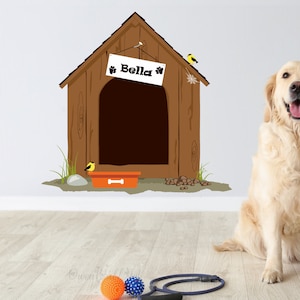 May include: A golden retriever dog sits in front of a brown wooden dog house with a sign that reads "Bella" on it. The dog house has a small orange food bowl and a few brown dog droppings in front of it.