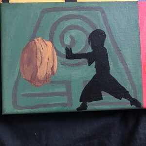 May include: A green canvas painting with a black silhouette of a person in a fighting stance. The person is standing on a symbol with a brown circle in the center. The background is a yellow, orange, and blue color.
