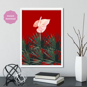 May include: A framed art print featuring a watercolor illustration of a light pink anthurium flower against a vibrant red background. The artwork includes green spiky leaves at the bottom. The words "Instant download" are in a pink circle in the upper left corner.