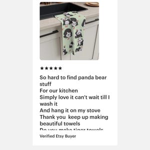 May include: A green kitchen towel with a repeating pattern of black and white panda bears. The towel is hanging on a kitchen cabinet handle. The text "So hard to find panda bear stuff" is written below the image.