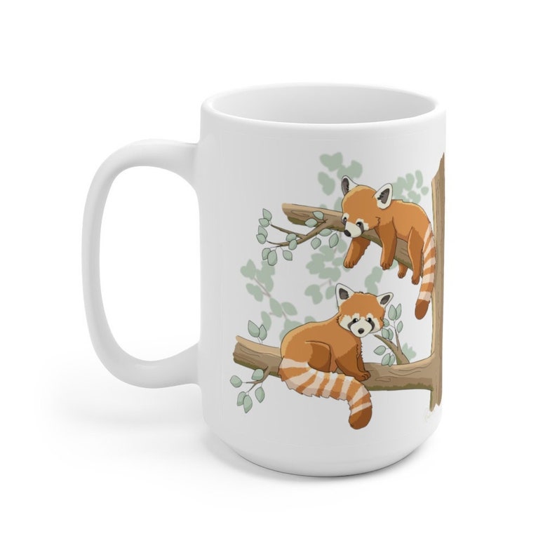 May include: White ceramic mug with a red panda design. Two red pandas are perched on branches of a tree with green leaves. The mug has a white handle.