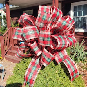 Christmas tree bow topper. Plaid Christmas bow topper with wire. Can be shaped anyway you like. Red, green, white plaid ribbon. Dove tails