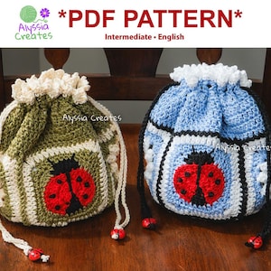 May include: Two crocheted drawstring bags, one green and one blue, each with a red ladybug design. The bags have white drawstrings with ladybug-shaped beads. The text "*PDF PATTERN*" and "Alyssia Creates" are visible.
