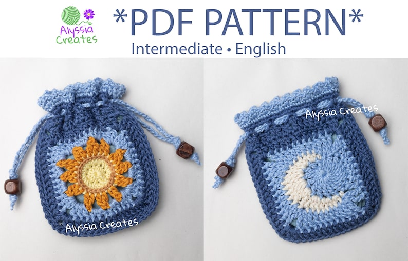 May include: Two crocheted drawstring bags with different designs. One bag features a sunflower motif in yellow, orange, and white. The other bag features a crescent moon motif in blue and white. Both bags are blue and have wooden toggles.