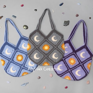 May include: Three crocheted tote bags with a sun and moon design. The bags are in blue, purple, and gray.