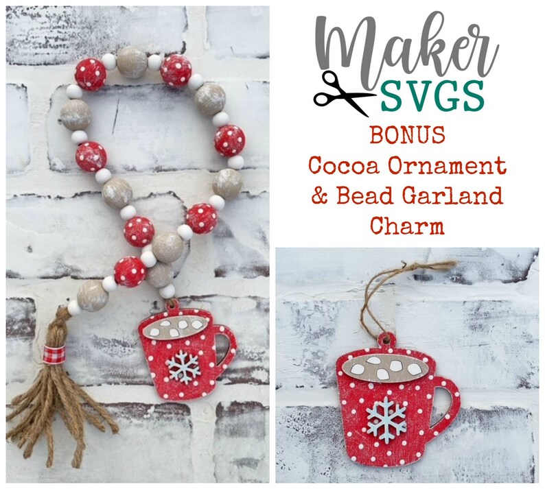 May include: A red and white cocoa mug ornament with a snowflake and marshmallows, hanging from a brown twine string. A red and white bead garland with a brown tassel hangs from a white brick wall. The text "Maker SVGs BONUS Cocoa Ornament & Bead Garland Charm" is displayed in the image.