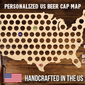 May include: A wooden map of the United States with 94 circles to hold beer bottle caps. The map is handcrafted in the US and fits 94 beer caps. The text "PERSONALIZED US BEER CAP MAP" and "HANDCRAFTED IN THE US" is visible on the map. Two beer bottles are in the foreground.